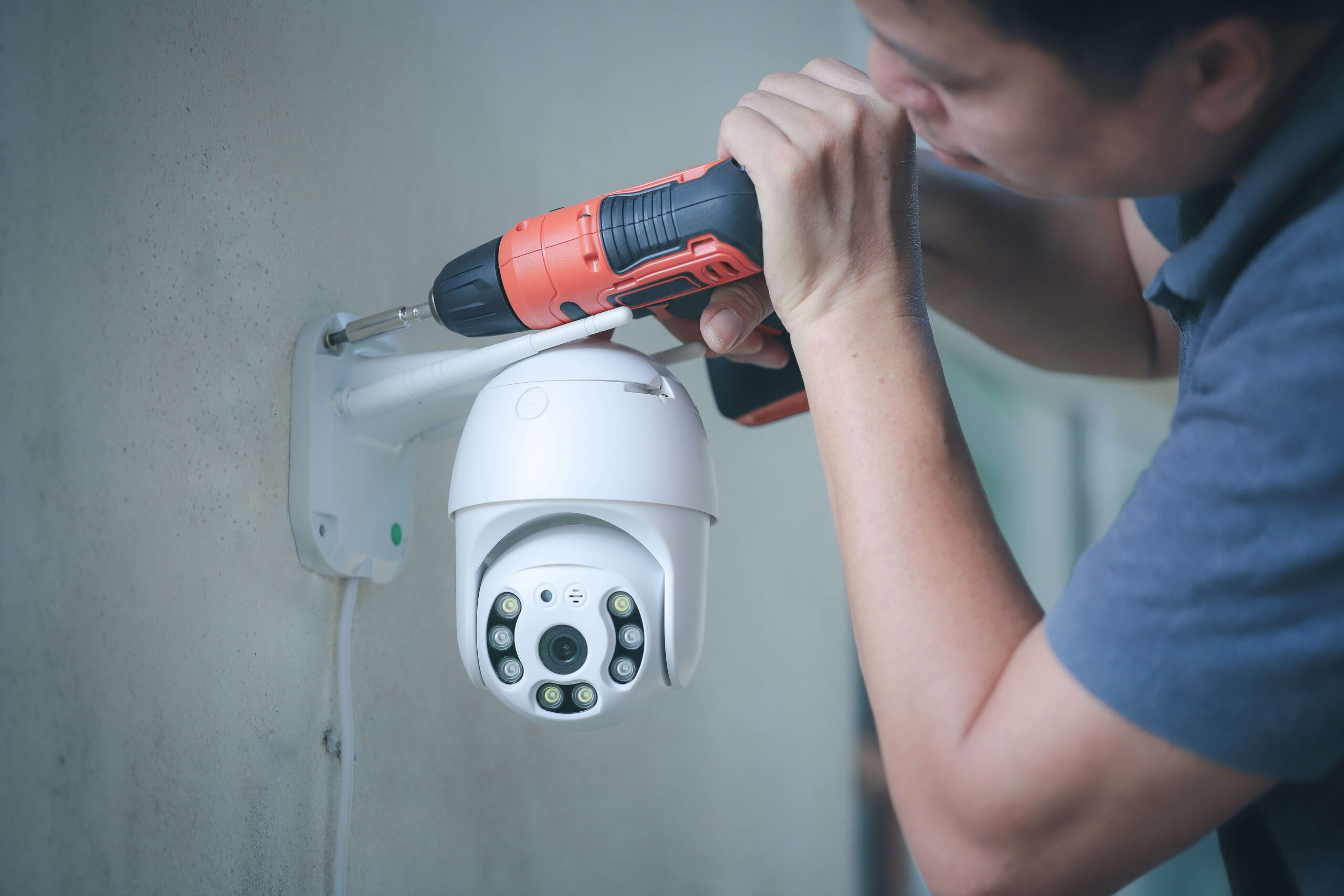 Man installing security camera CCTV wireless security equipment